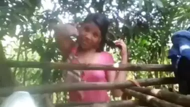 Village girl changing dress ouitdoors after bath