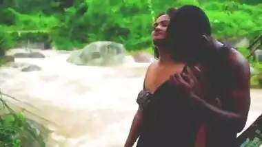 A horny couple fucks near a waterfall on a rainy day