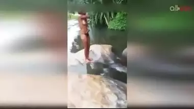 Lewd amateur Desi aunty flashing her nice big tits while bathing outdoor