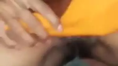 Indian babe lifts yellow sari and shows off pretty hairy pussy