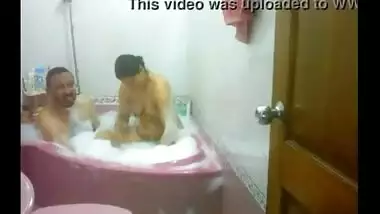 Mature couple enjoy a romantic bath in their bathtub