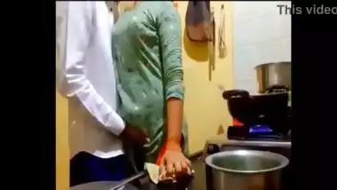 indian new married couple romance in kitchen.