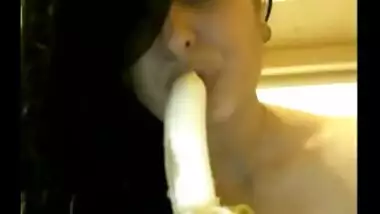 Naughty Indian babe sucking a banana on camera