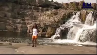 Outdoor romance under waterfall in bollywood