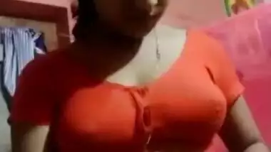 Aroused Desi wife slowly takes red top off to expose boobs for XXX fans