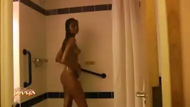 She drops the top and walks into the shower...