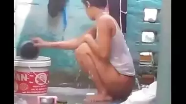 Young village girl taking a bath