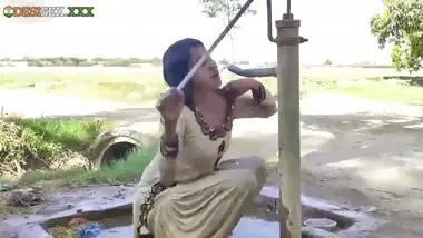 Young village school girl taking a bath in a sari and caught on camera