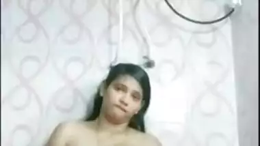 Indian girl with juicy melons satisfies pussy in the shower room