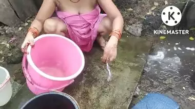 Indian house wife bathing outside