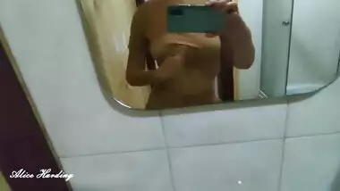 Alice takes a selfie and shows her tits and pussy in the shower room